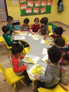 Children sitting around a table doing an activity