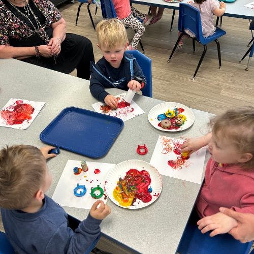 Children painting at a table