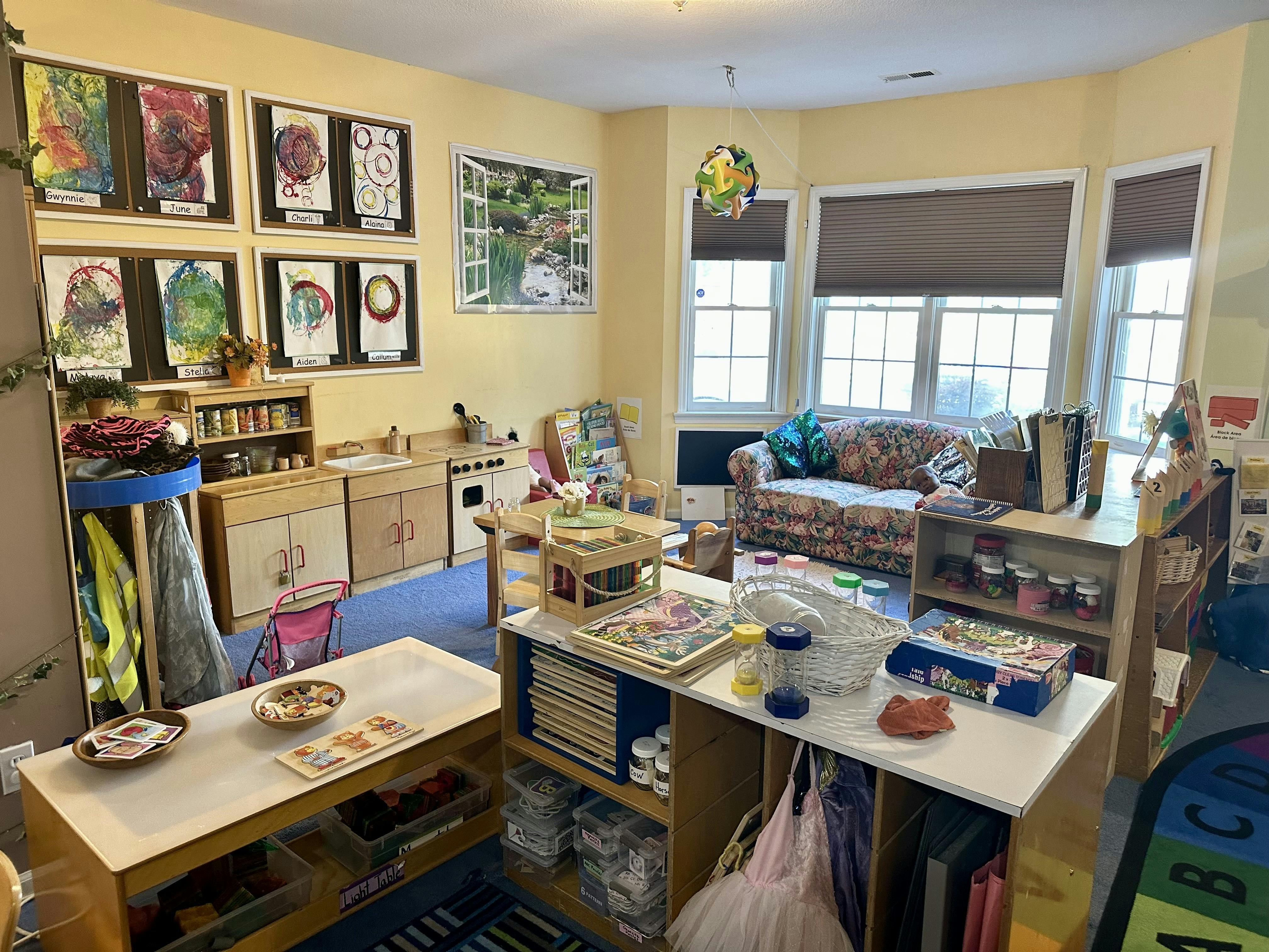 Playroom with child-sized furniture and art displays on the walls