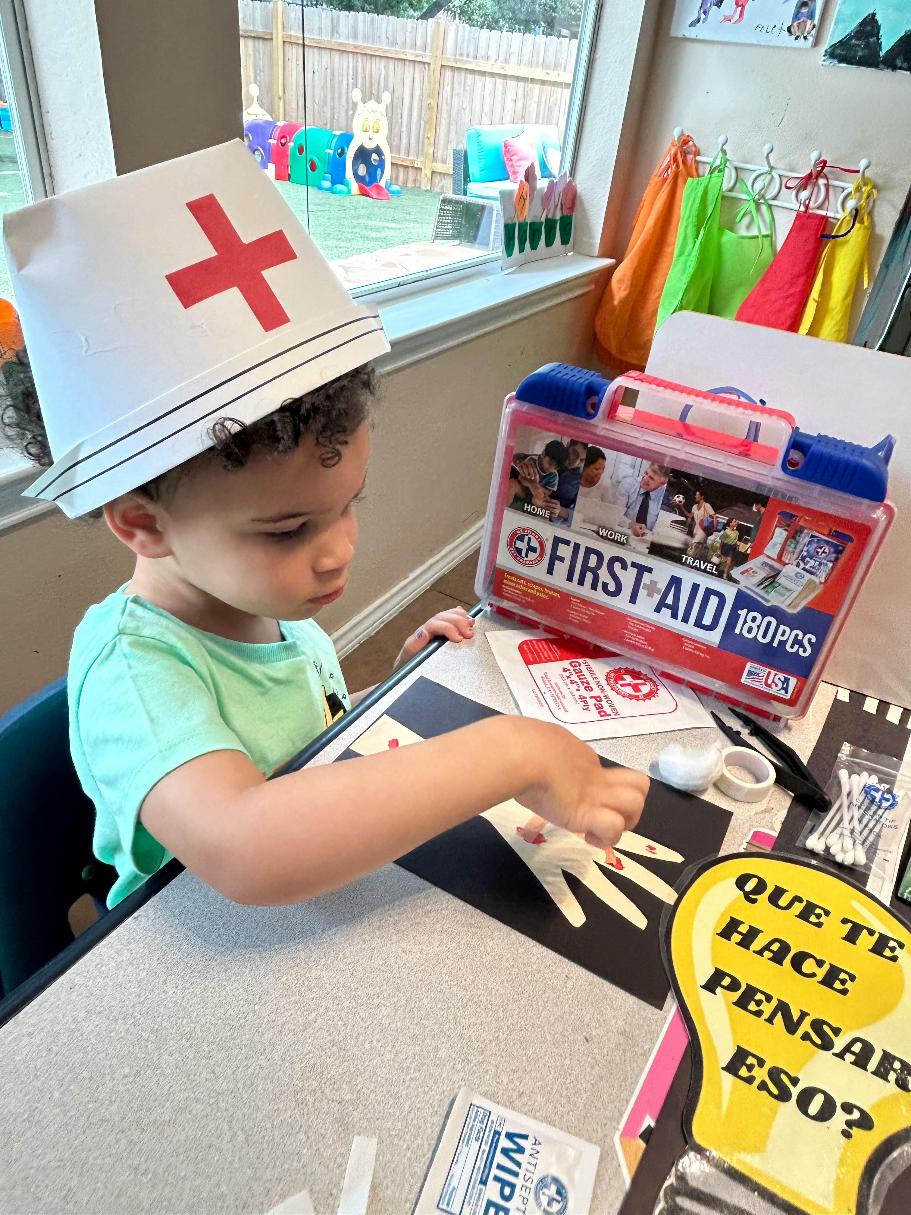 Child wearing a nurse's hat playing with a first aid kit