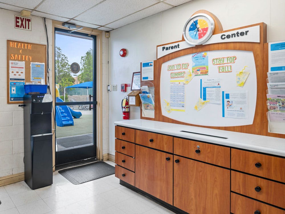 Parent information board, water cooler, and exit door to a playground