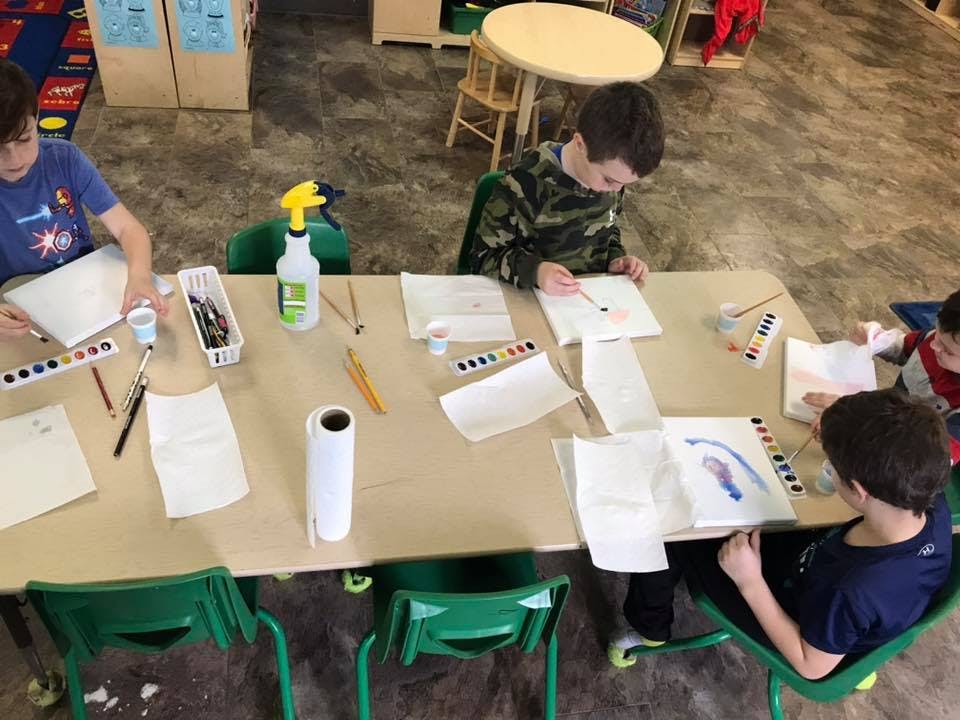 Children painting at a table