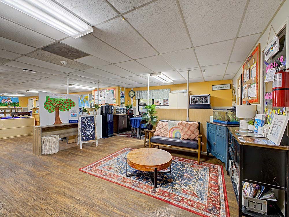 Classroom interior with seating area, bulletin board, and student artwork