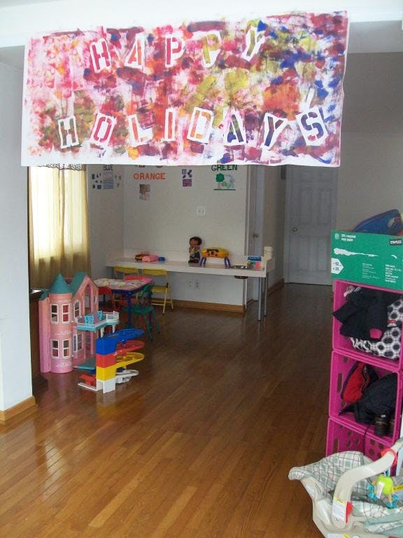 Happy Holidays banner above a room with toys and tables