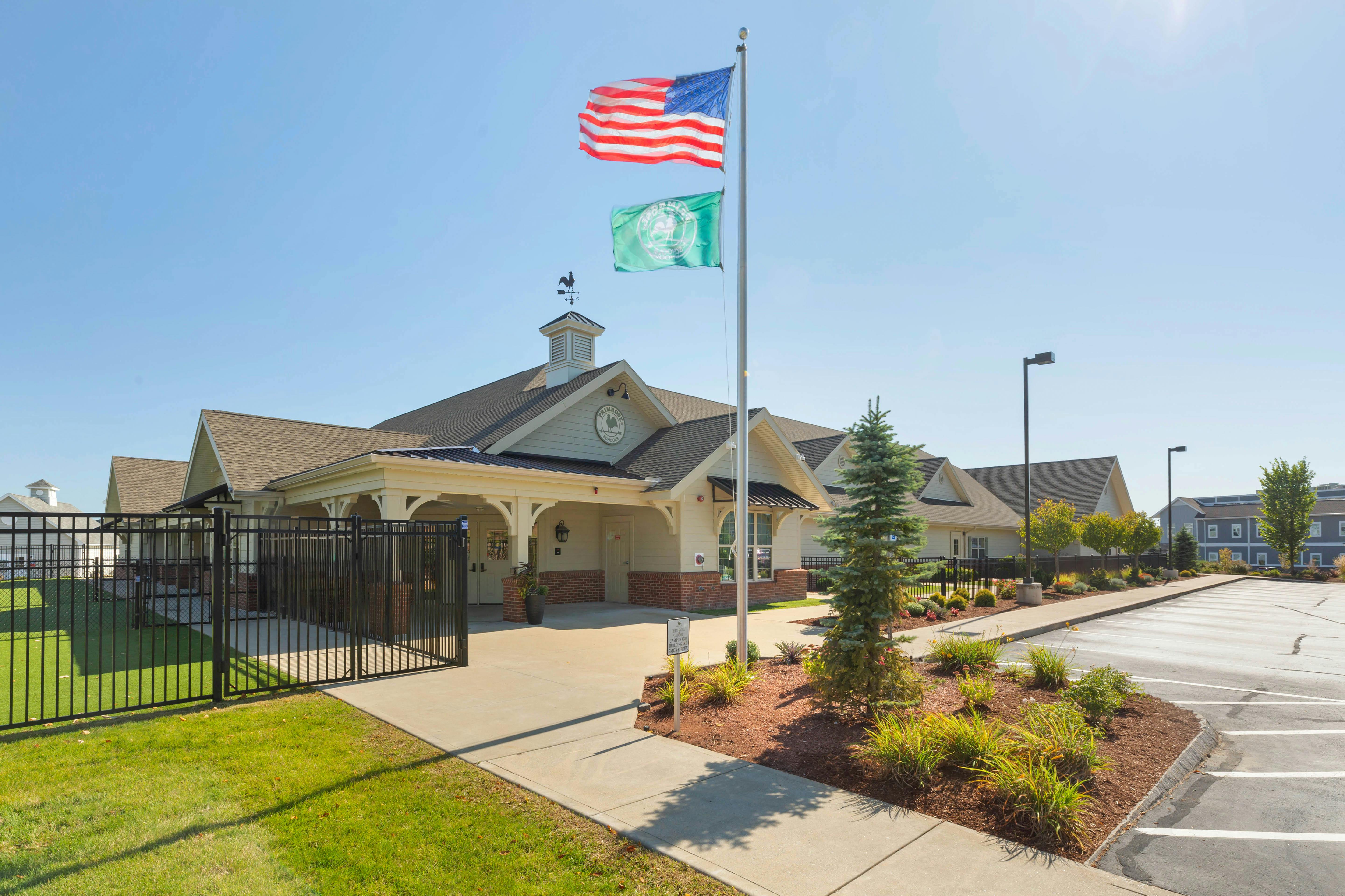 Exterior view of a school building with flags flying