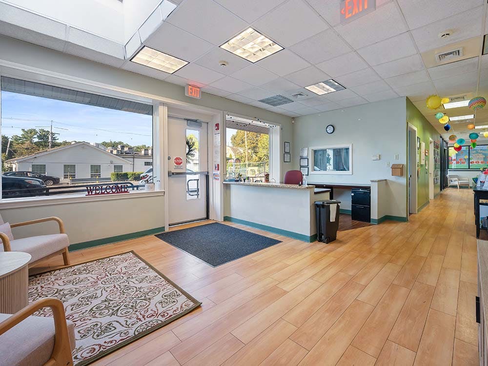 Reception area with a "Welcome" sign on a window and a counter