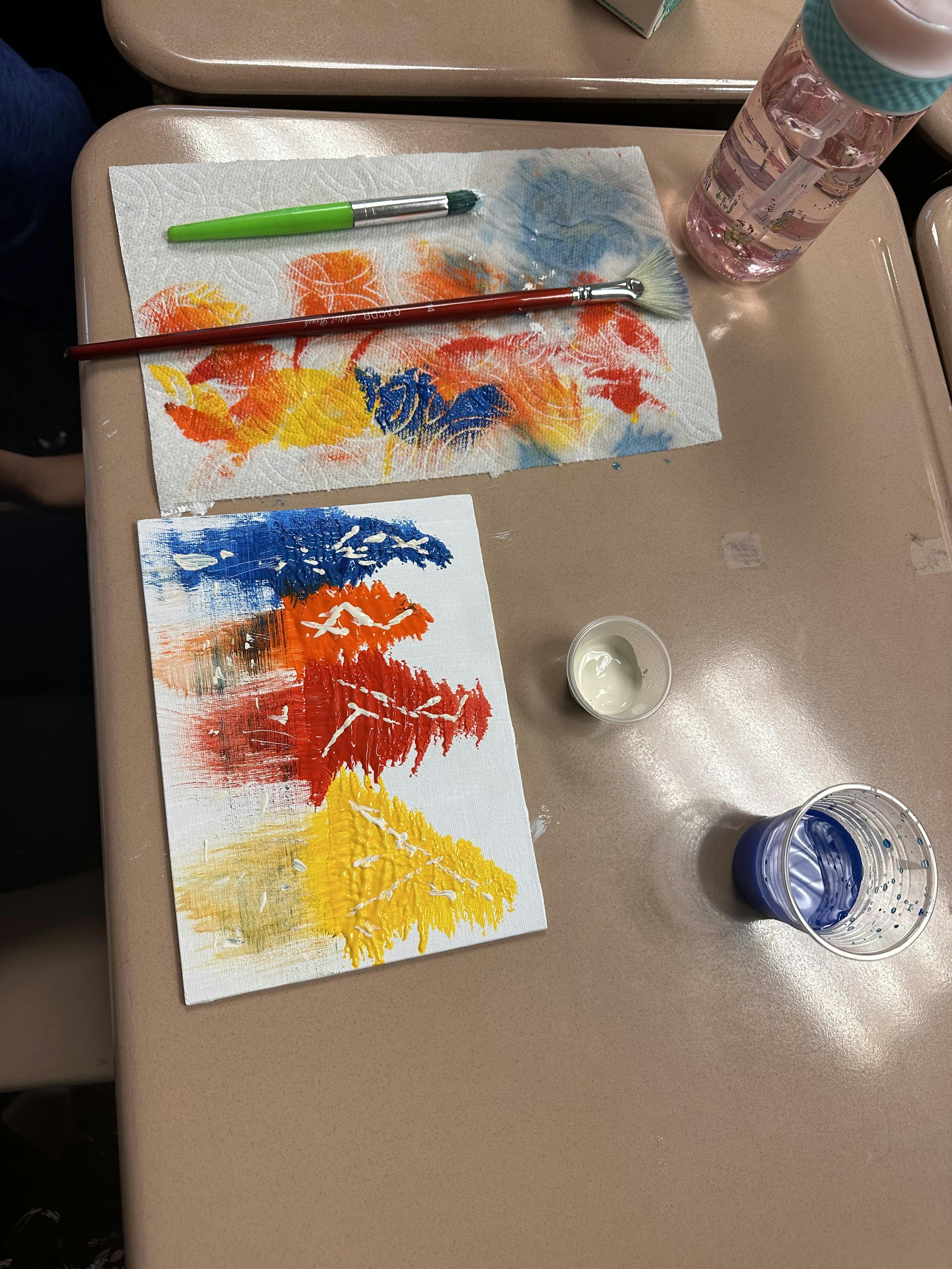 Paintbrushes and colorful paint swatches on paper