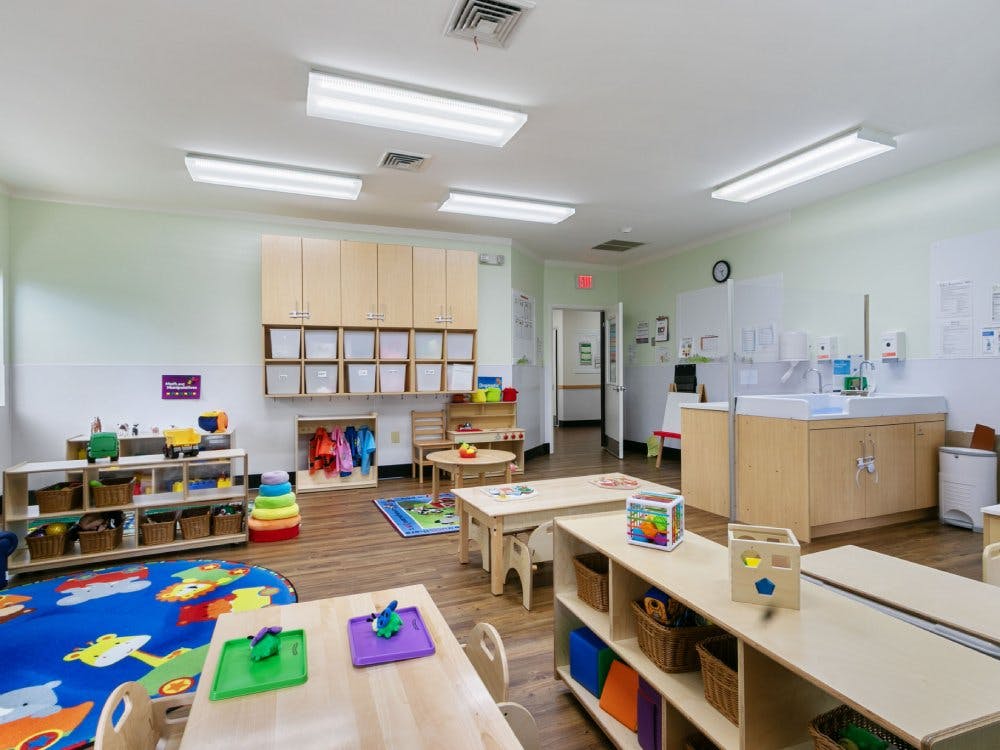 Empty colorful children's classroom with small tables and chairs