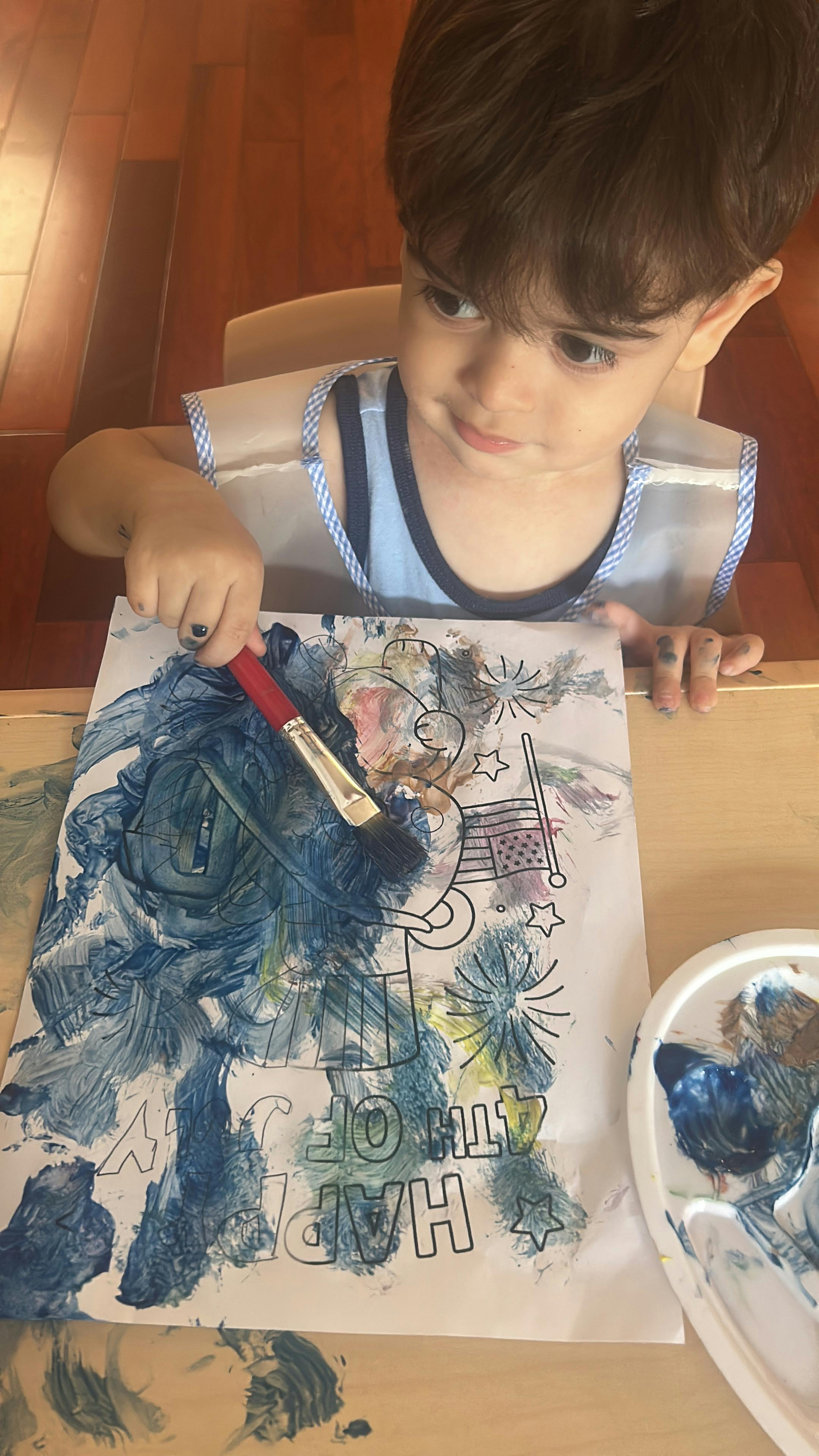 Child painting on a Happy 4th of July coloring page