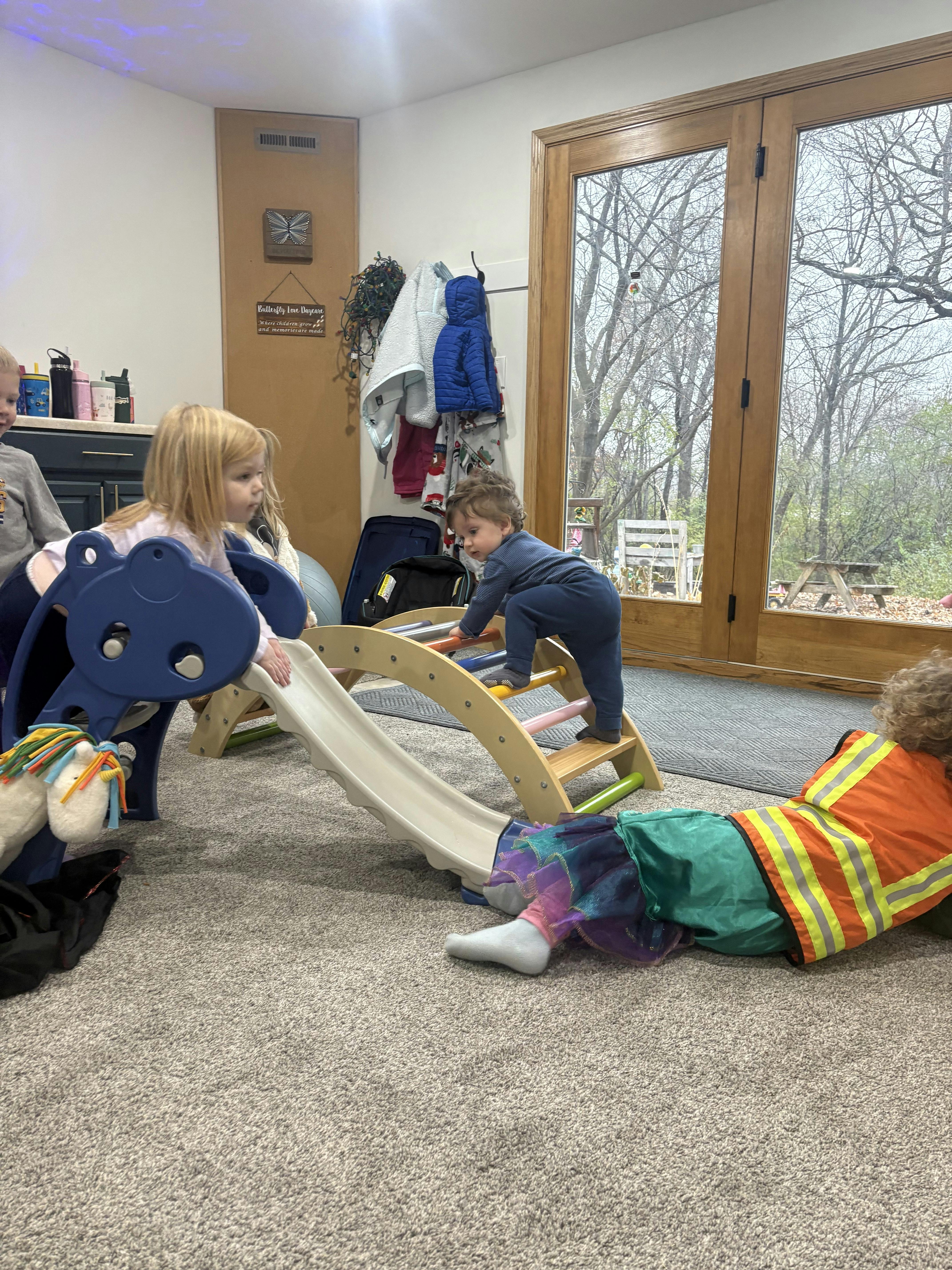 Children playing on indoor slides and climbing structures