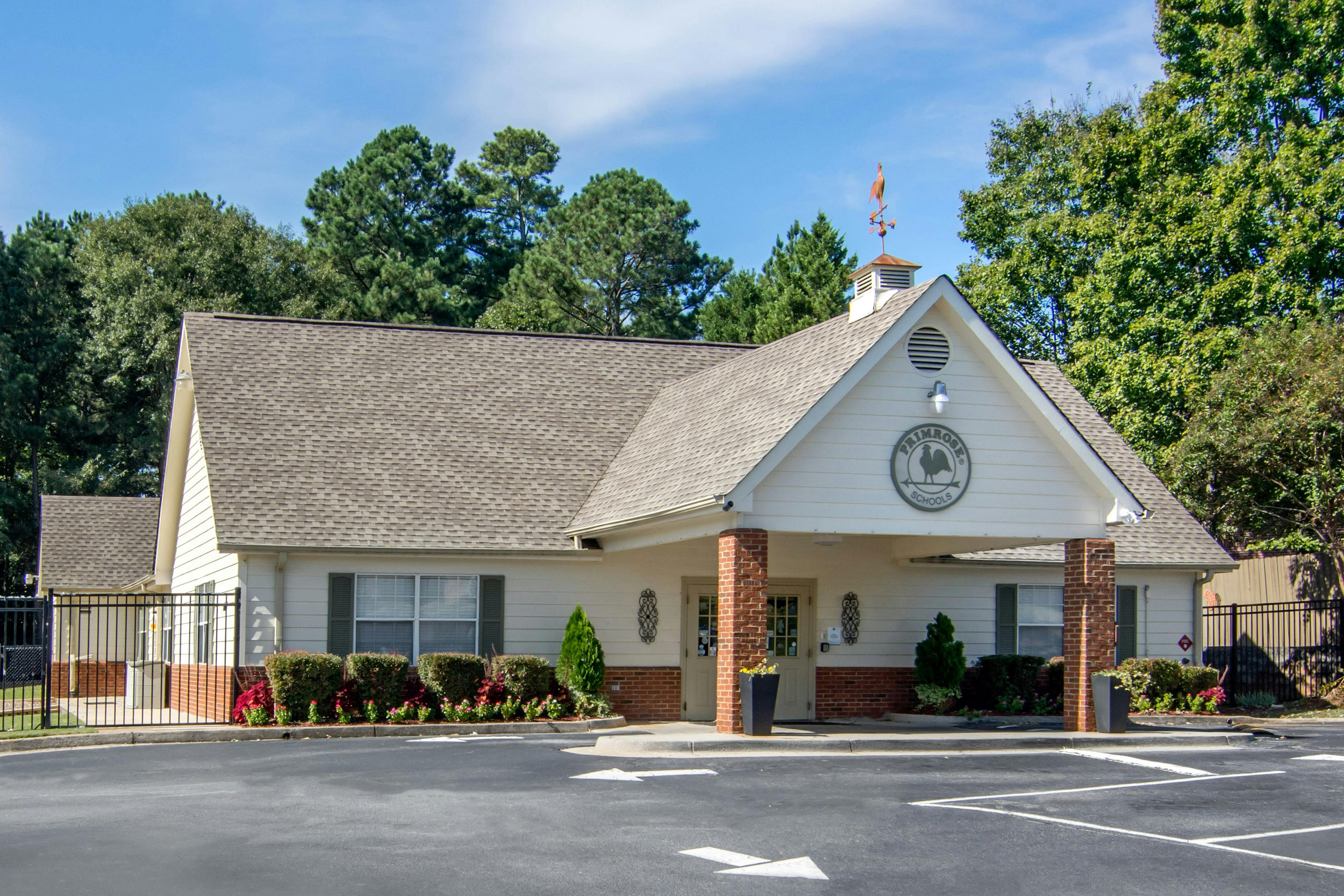 Single-story building with a sign that says Primrose Schools and a rooster weathervane