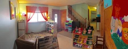 Room with a window, bed, shelves, and a staircase