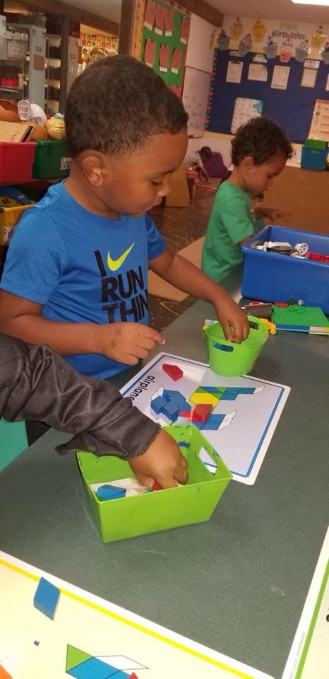 Child playing with colorful blocks at a table