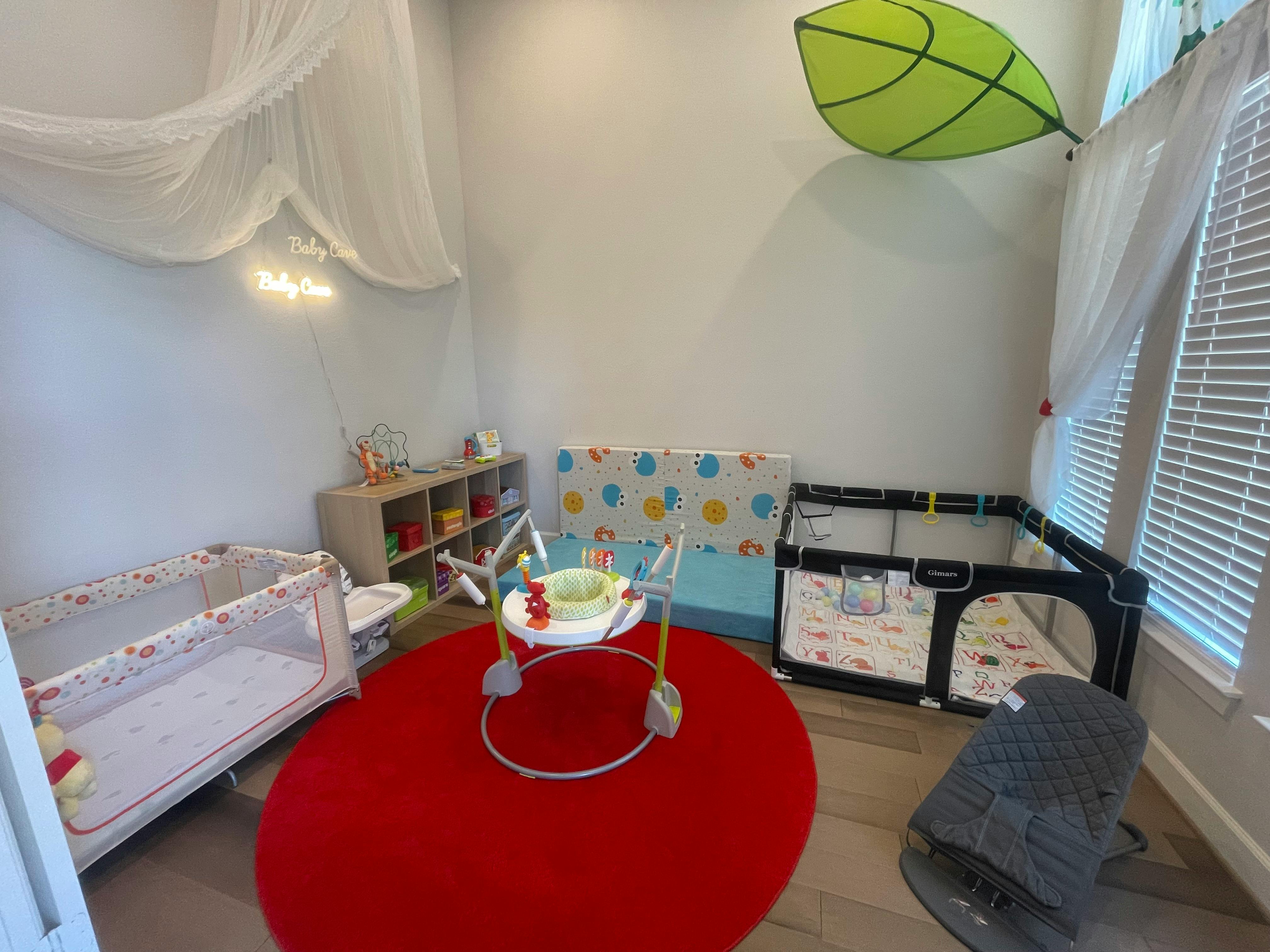 Nursery room with cribs, playpen, and baby walker on a red rug