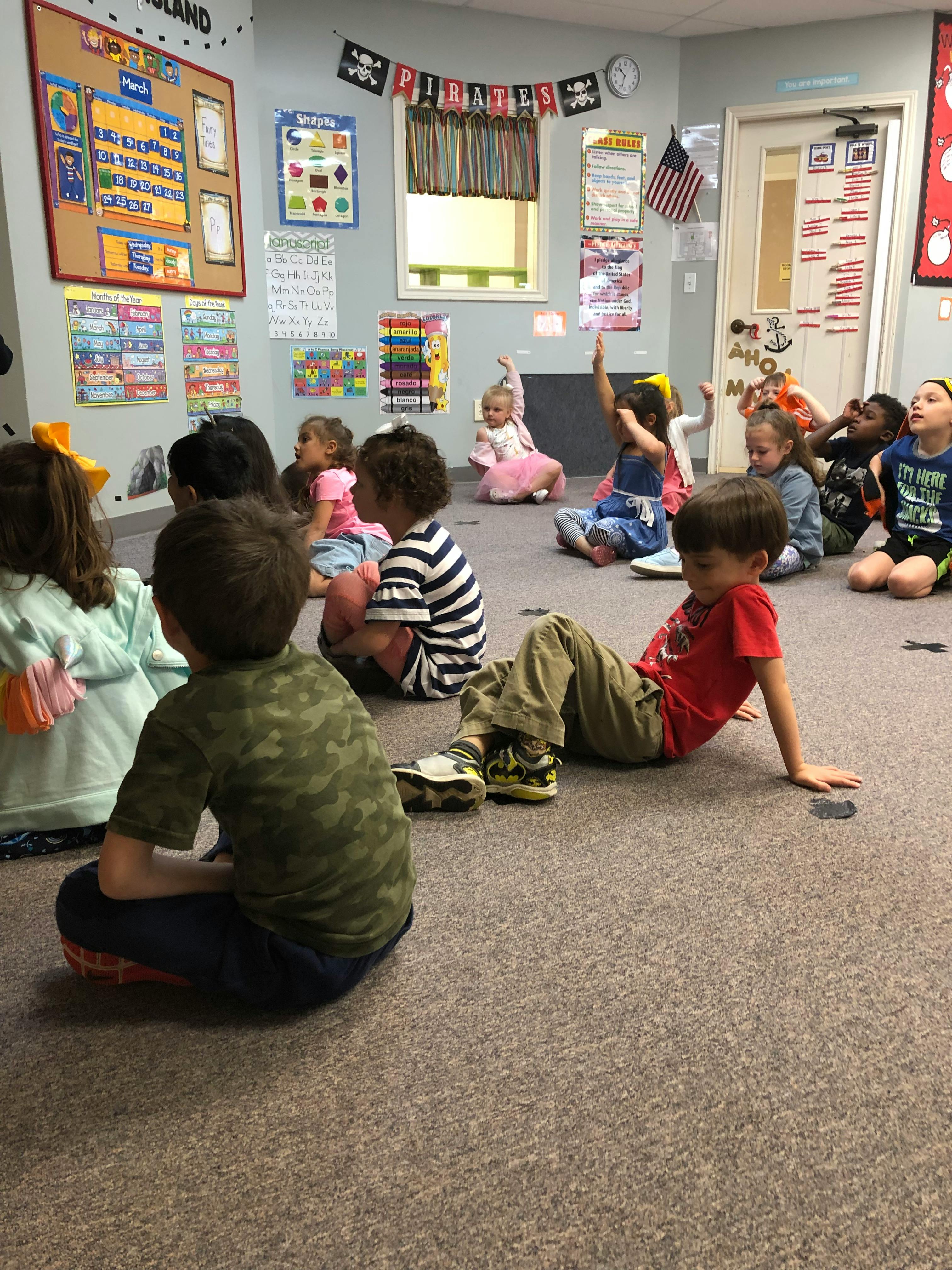 Children sitting on the floor in a classroom