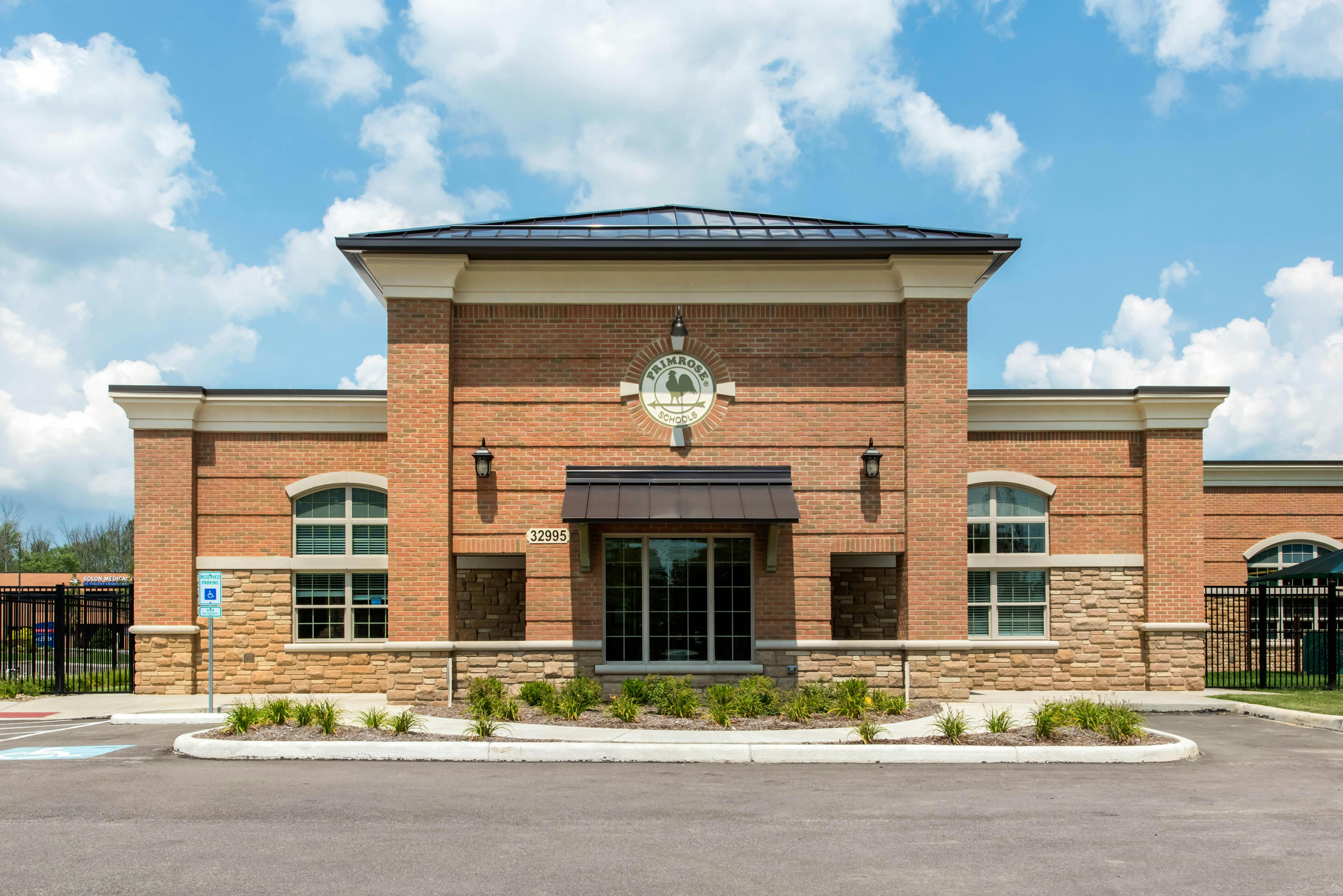 Exterior view of a brick building with a sign that reads "Primrose Schools"