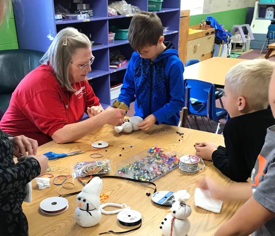 Adult and children crafting at a table