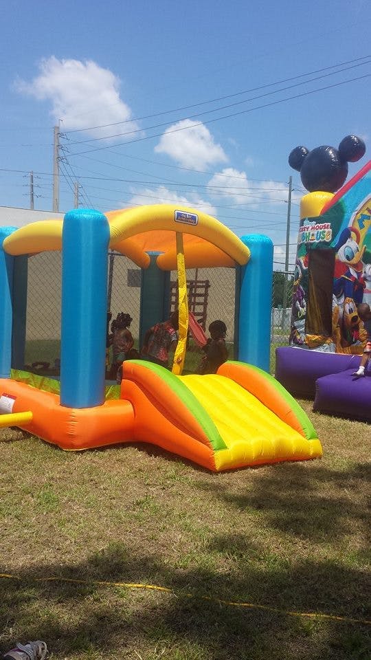 Inflatable bounce house with slide and children playing