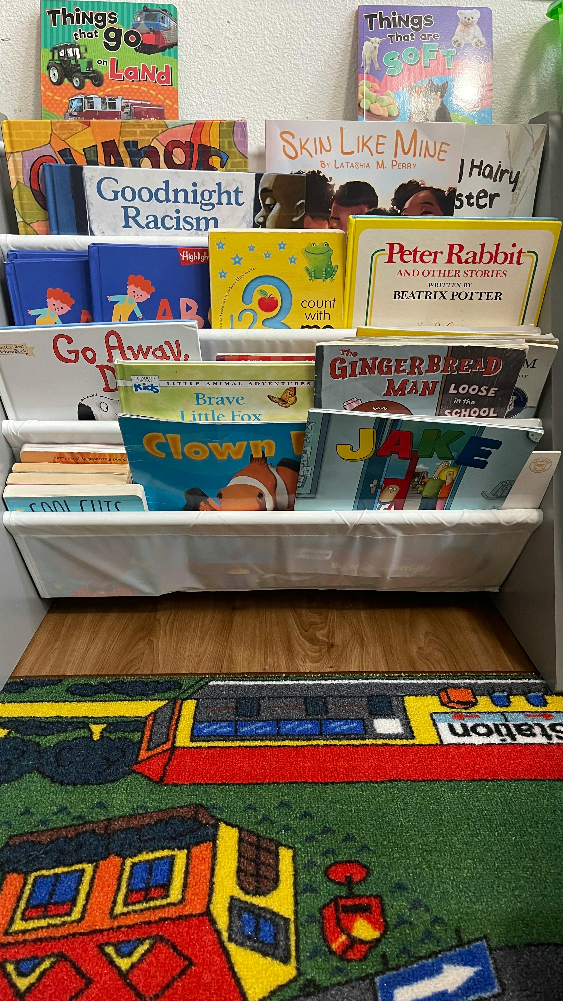 Children's books displayed in a tiered fabric book sling
