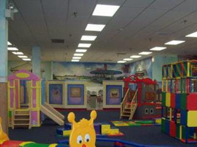 Indoor playground with colorful play structures and slides