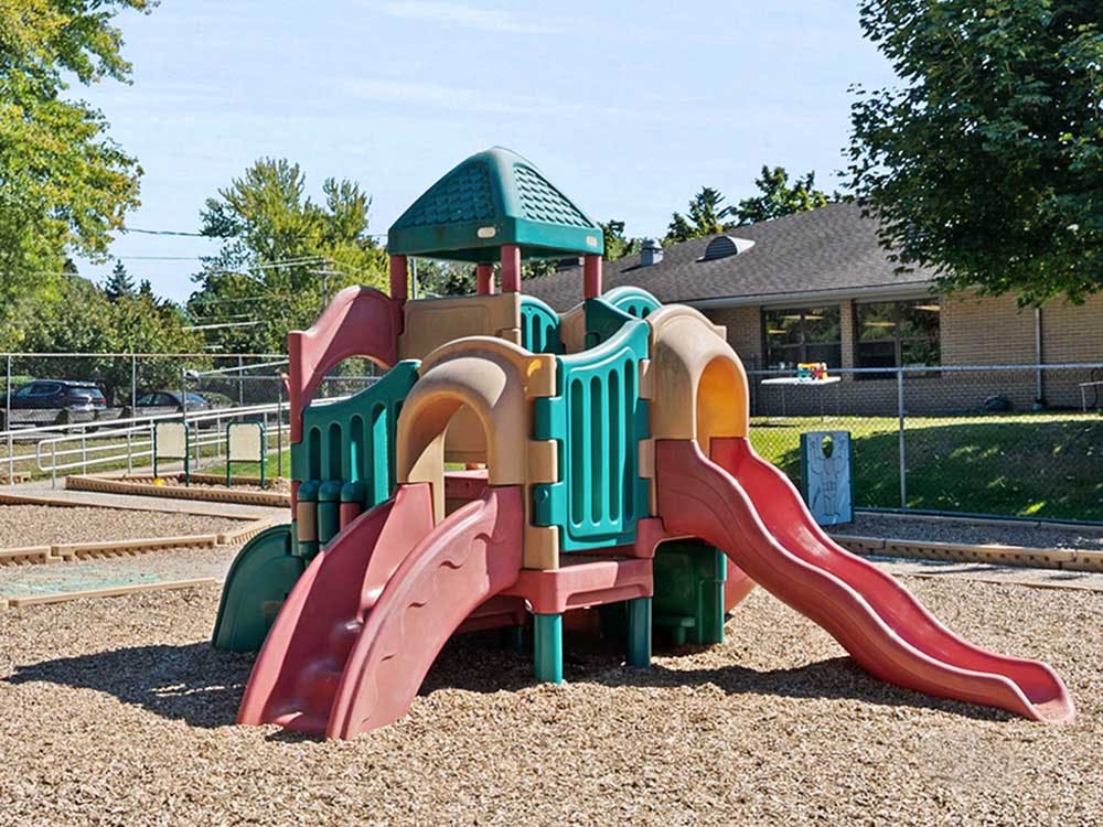 Colorful plastic playground structure with multiple slides and platforms