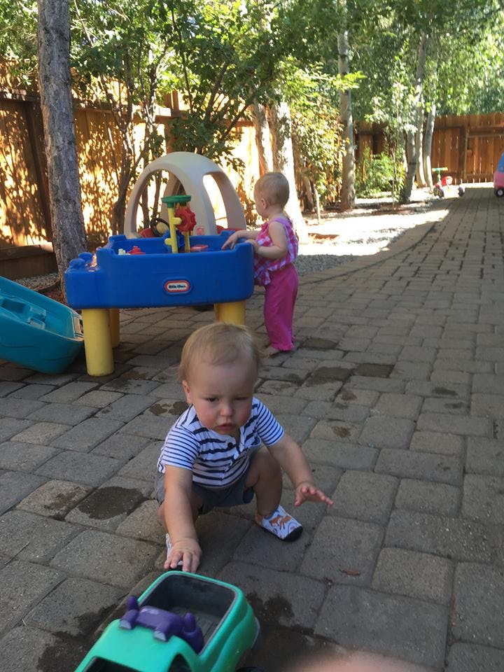Two children playing with toys outdoors