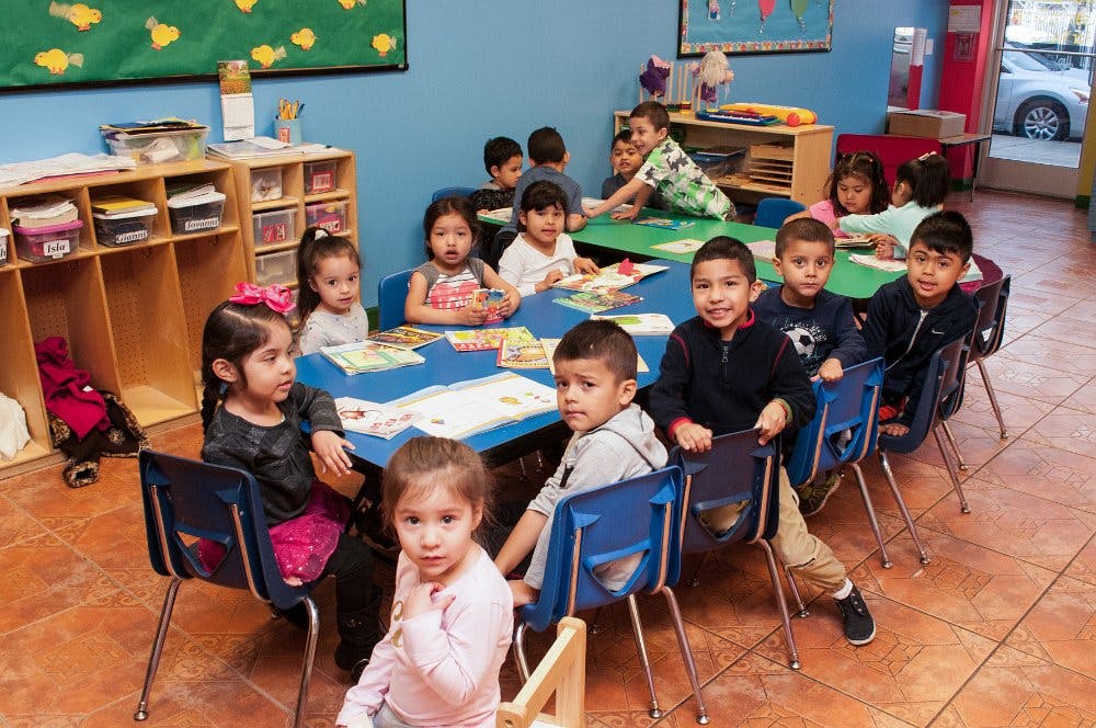 Children sitting at tables in a classroom