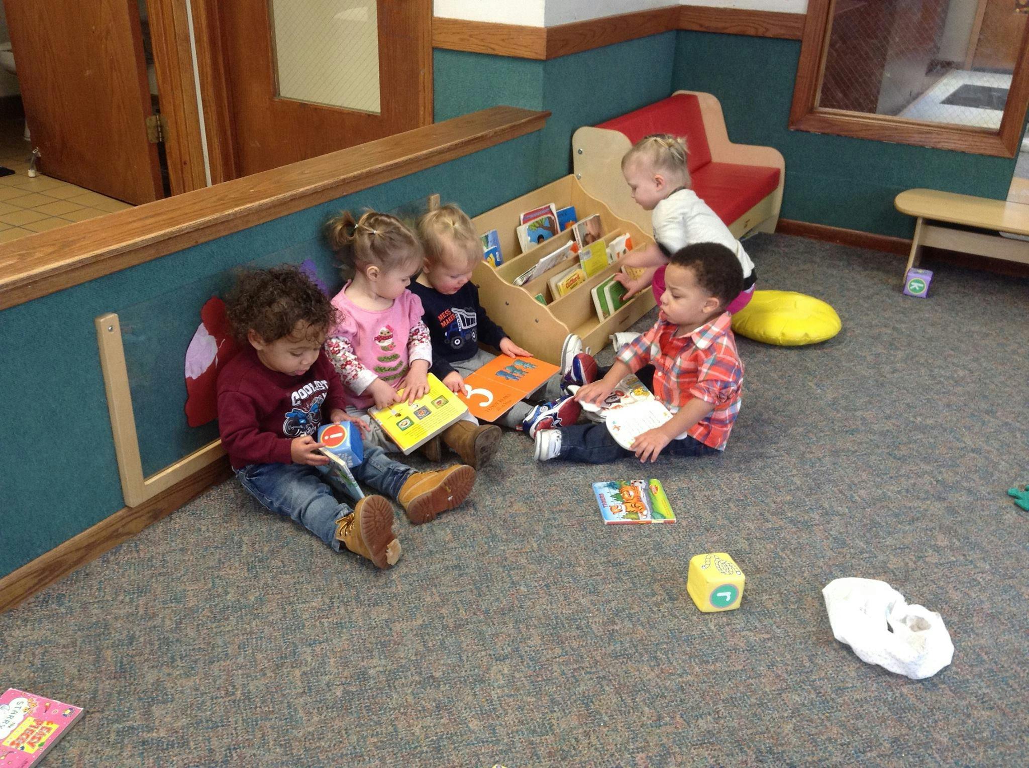 Children sitting on the floor reading books