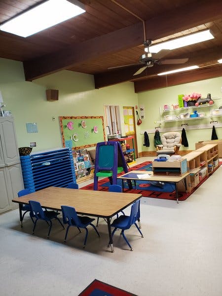 Classroom with tables, chairs, and learning materials