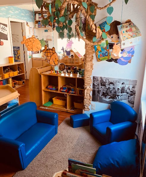 Playroom with blue children's furniture and a decorative tree