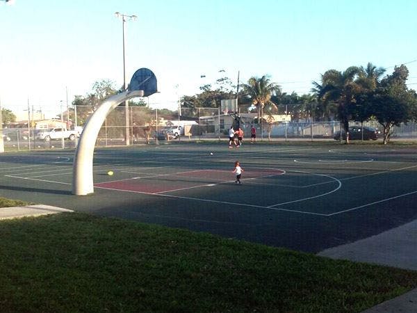 People playing basketball on an outdoor court