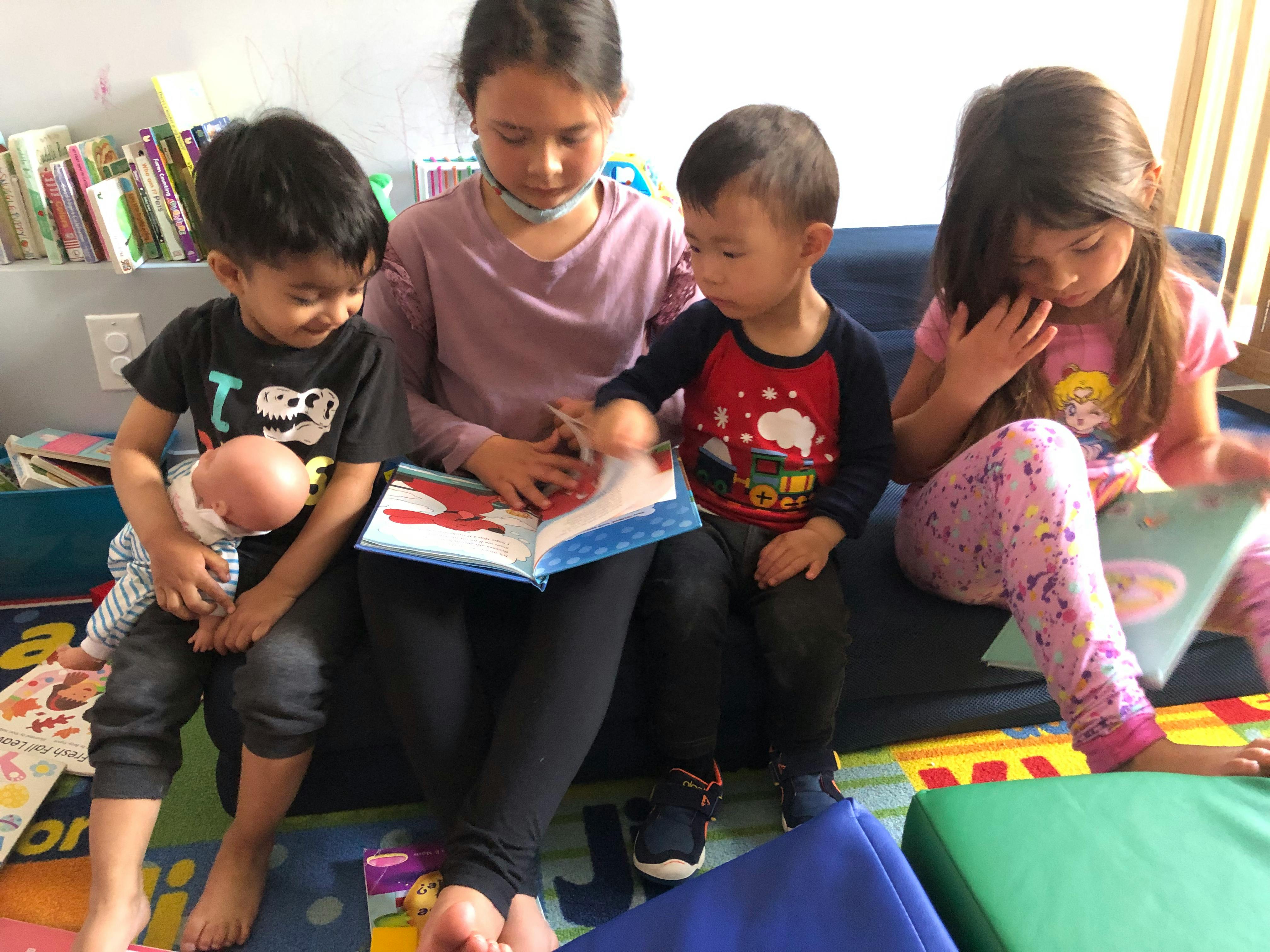 Four children reading books together