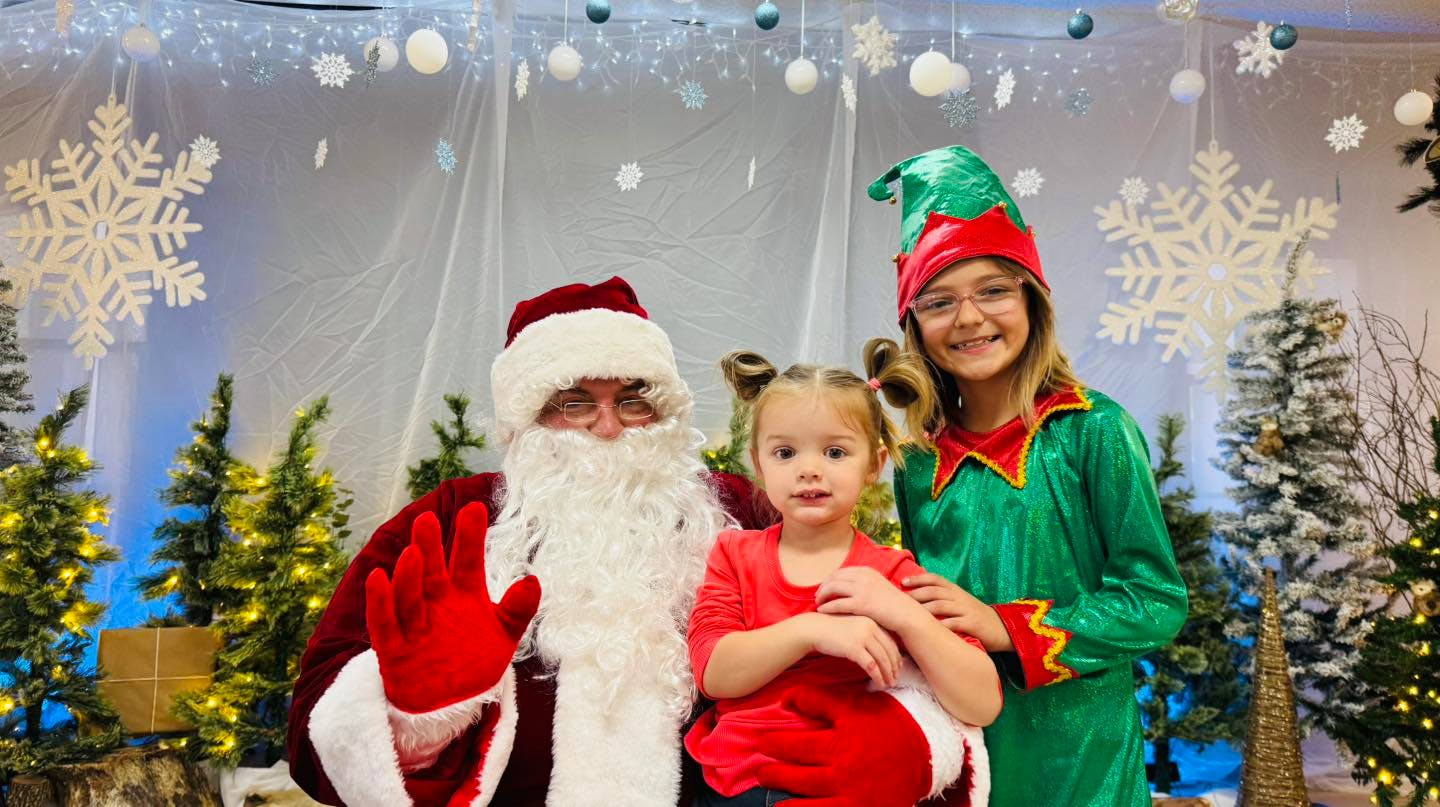 Santa with two children, one dressed as an elf