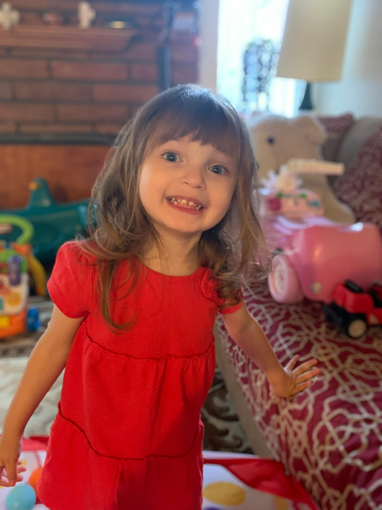Child with long hair and bangs smiling