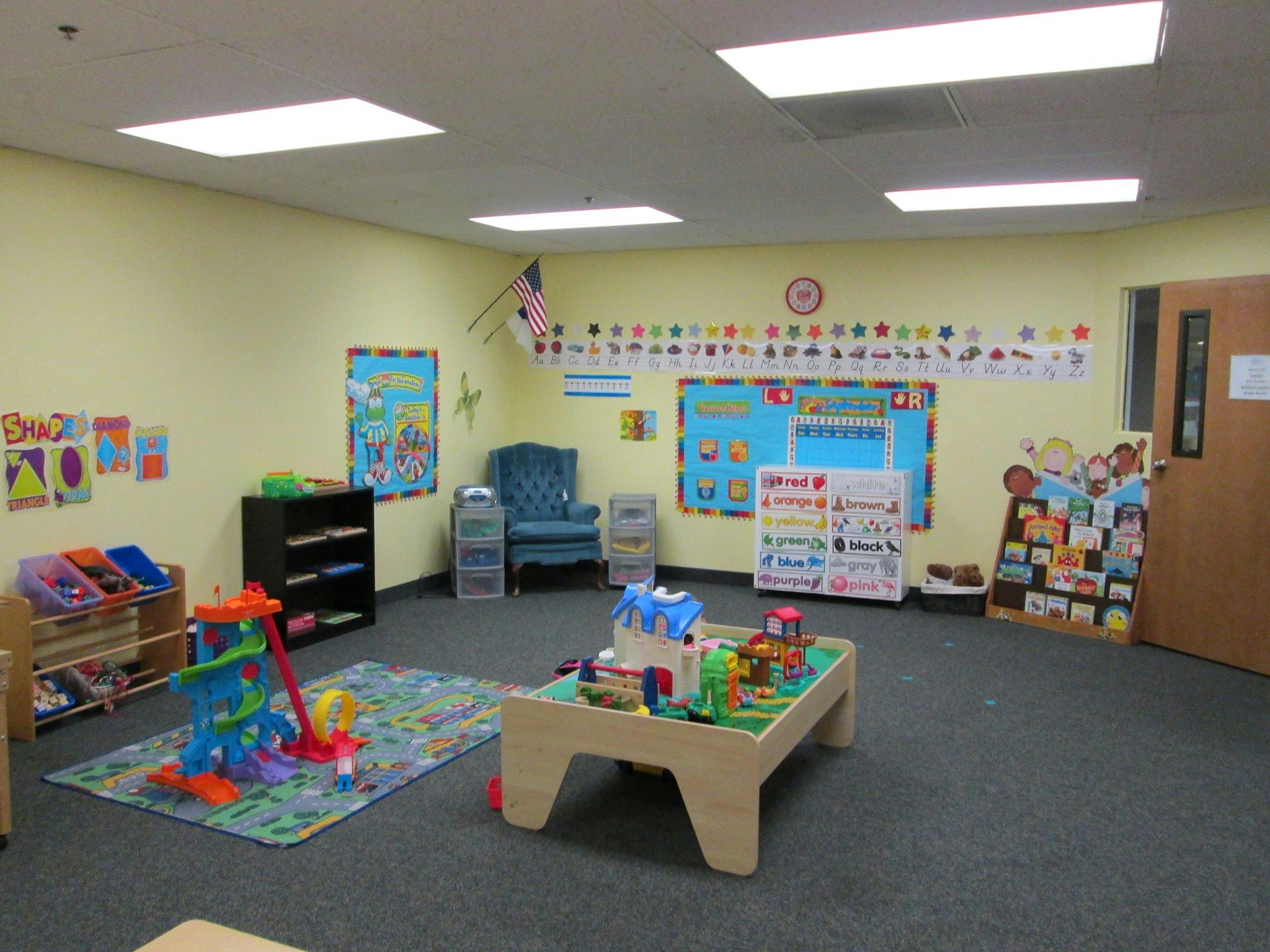 Playroom with toys, rug, and bulletin boards