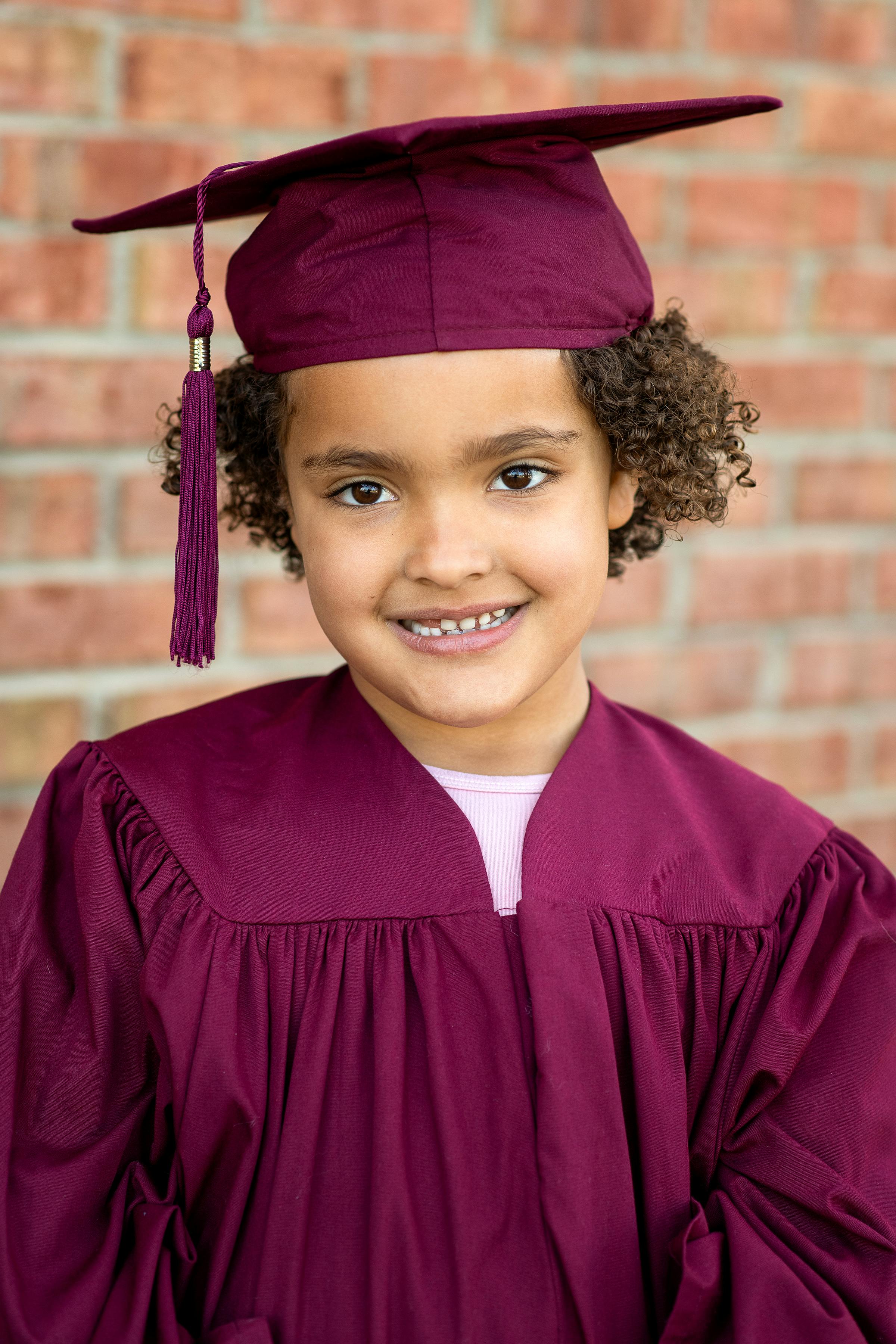 Child in a graduation cap and gown