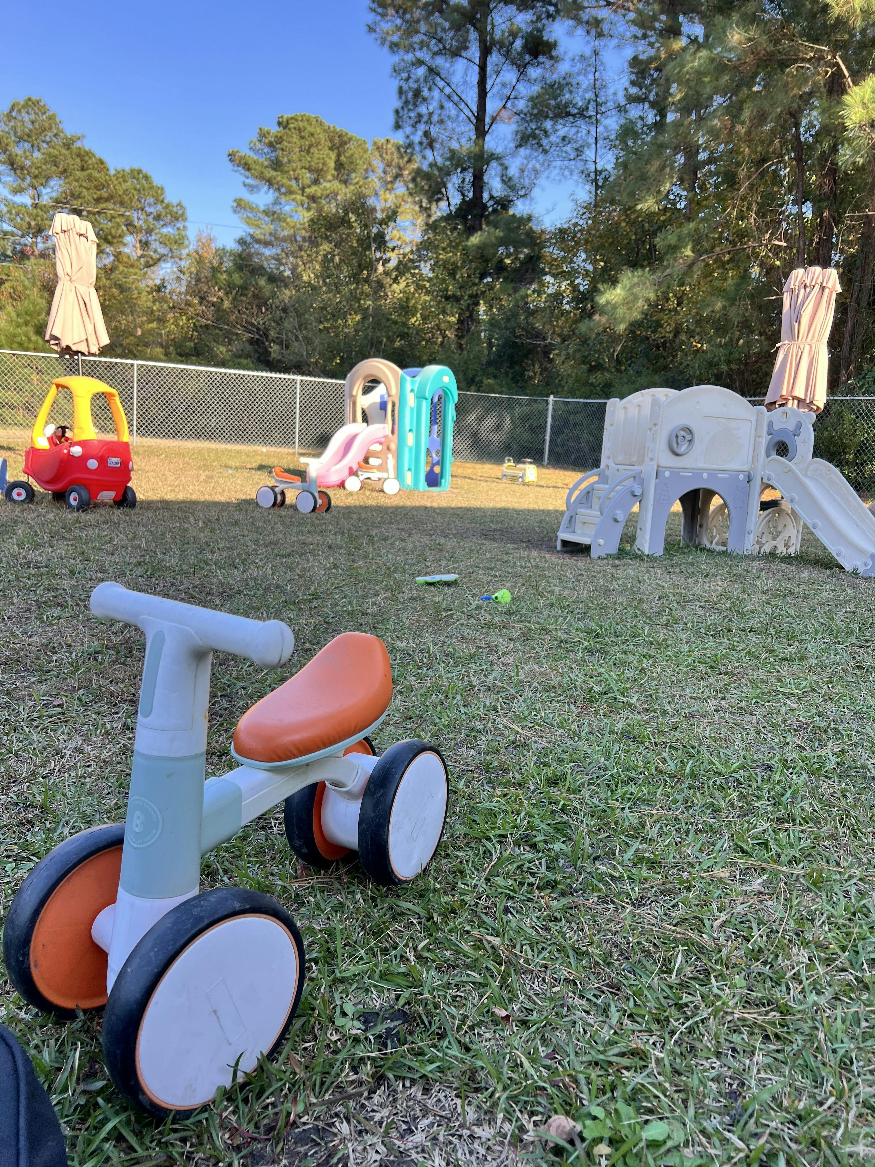 Outdoor playground with a small ride-on toy in the foreground