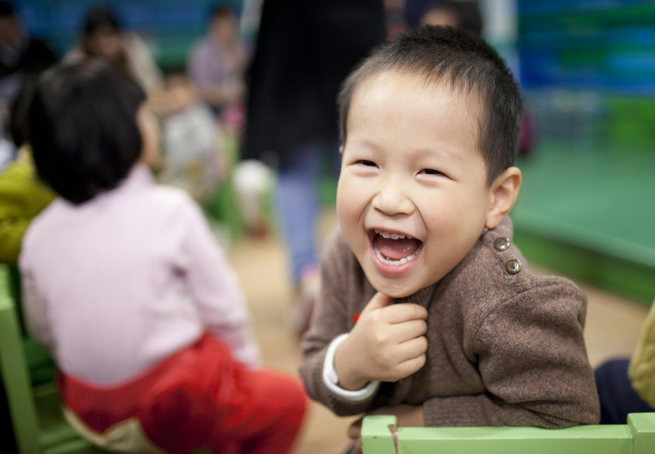 Child laughing with mouth open