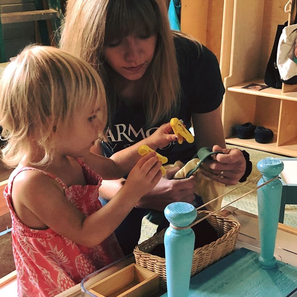 Person and child playing with yellow objects