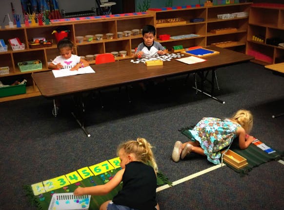 Children working on individual activities in a classroom