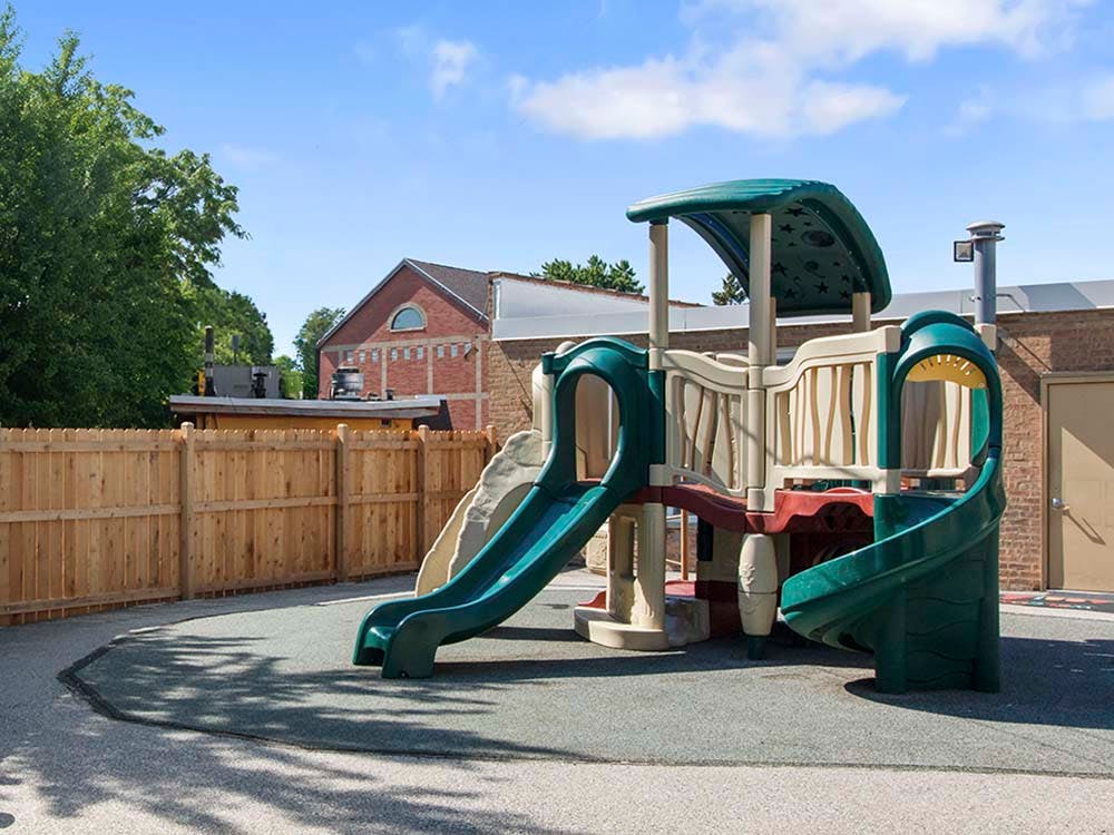 An outdoor playground with slides and climbing structures