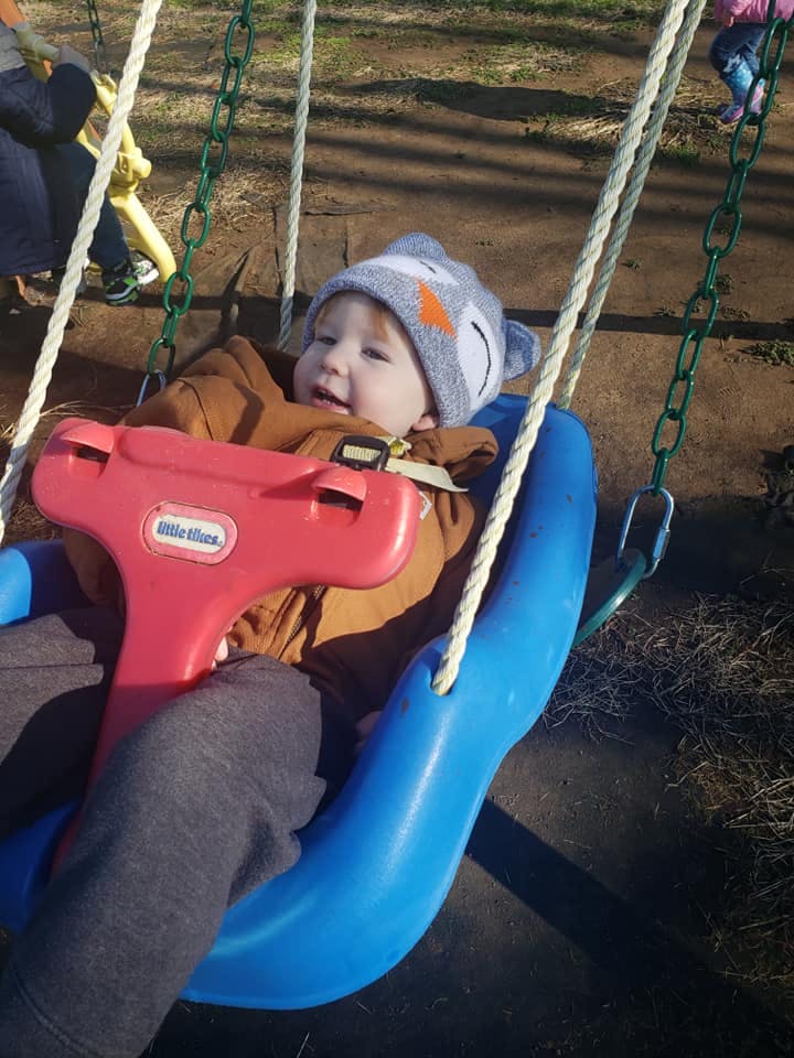 Child in a blue and red swing