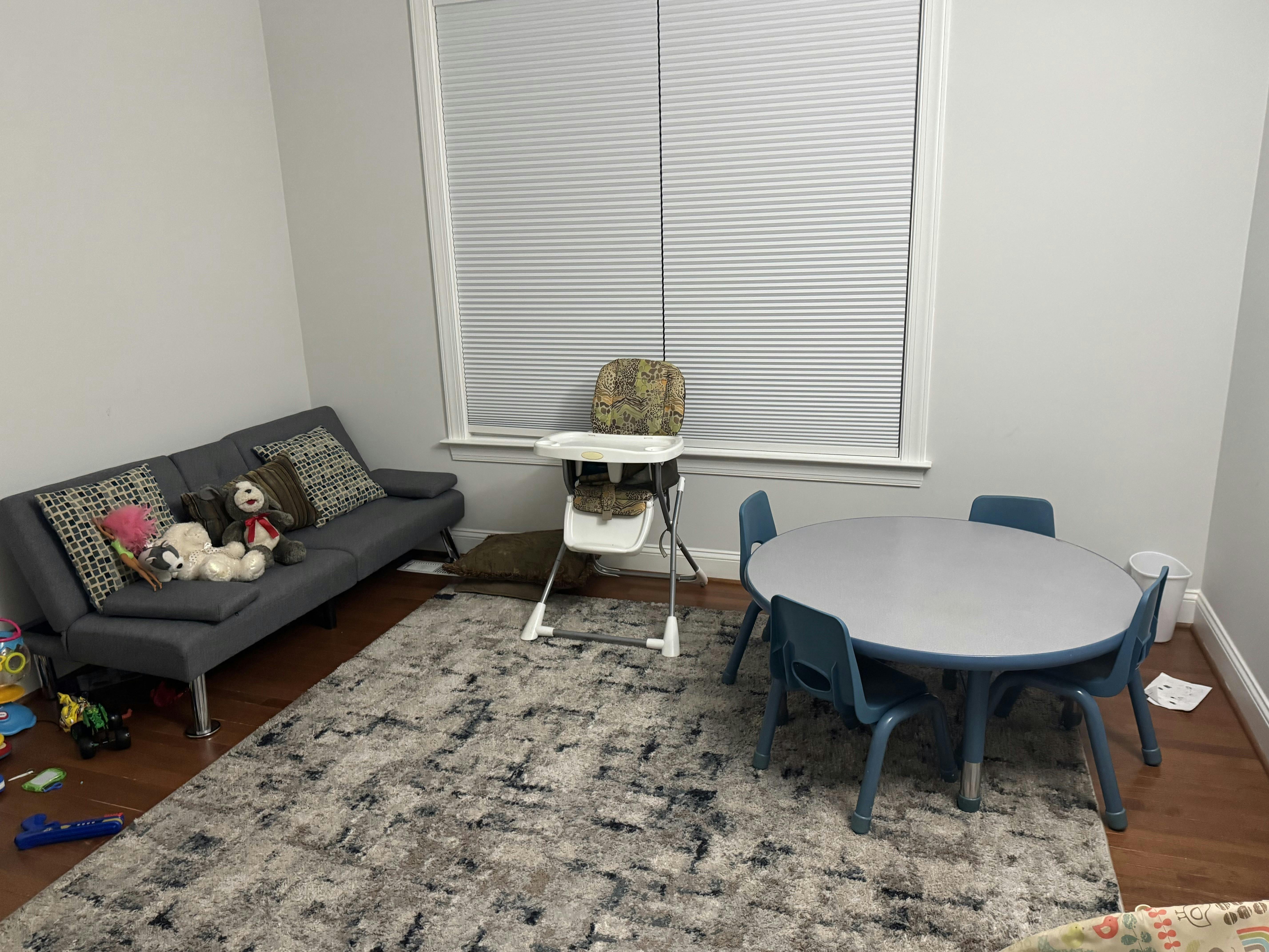 Sofa with stuffed animals, high chair, and child-sized table with chairs