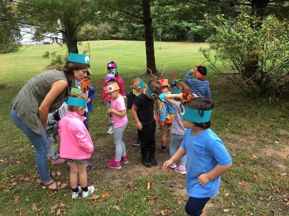 Adult and children wearing headbands with eyes outdoors