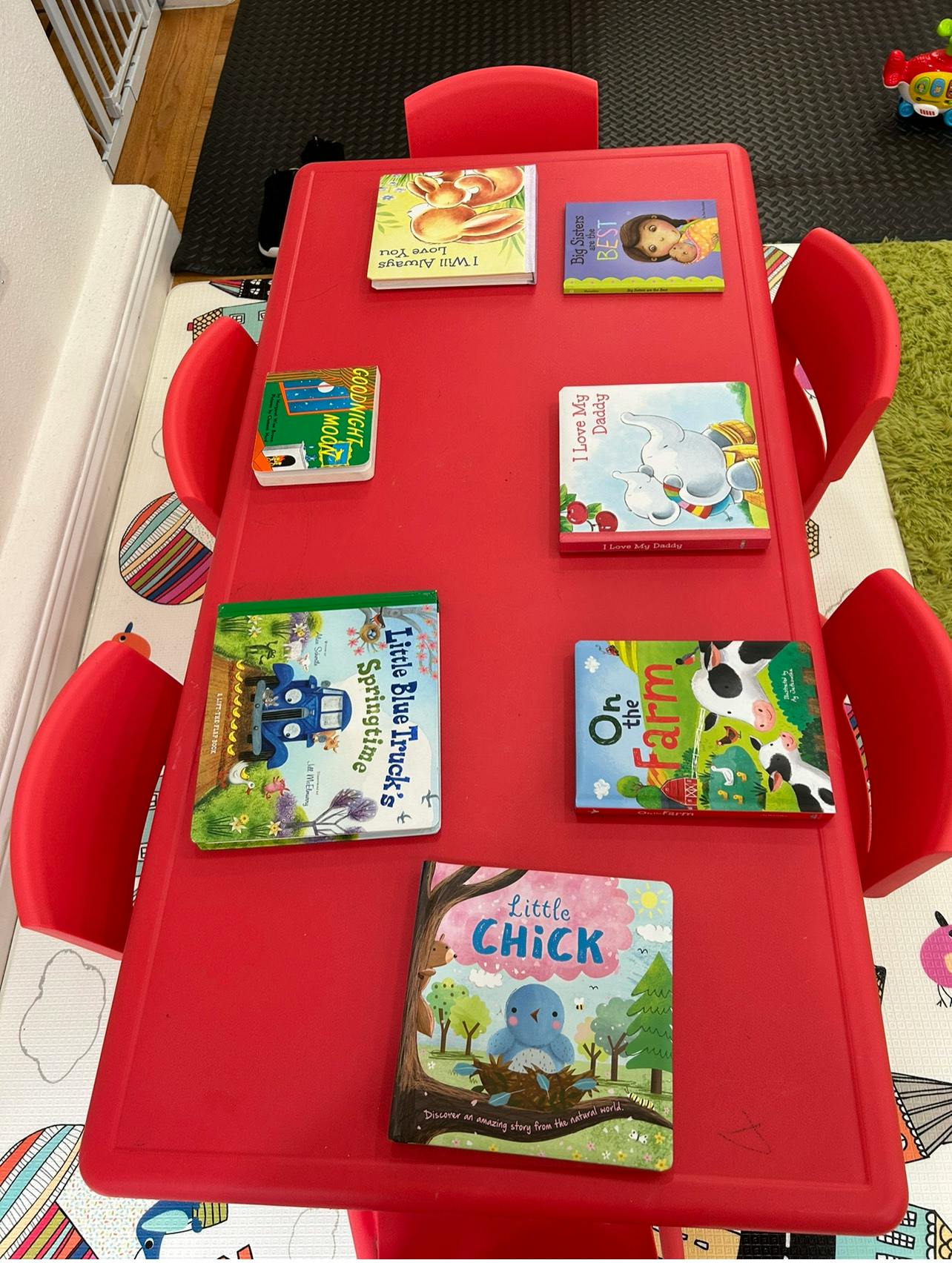 Children's books on a red table