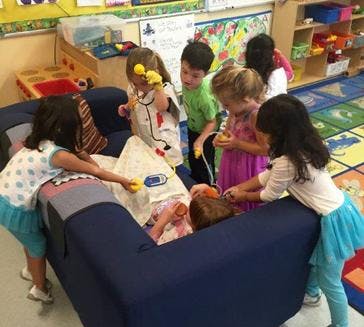 Children playing with toys in a classroom