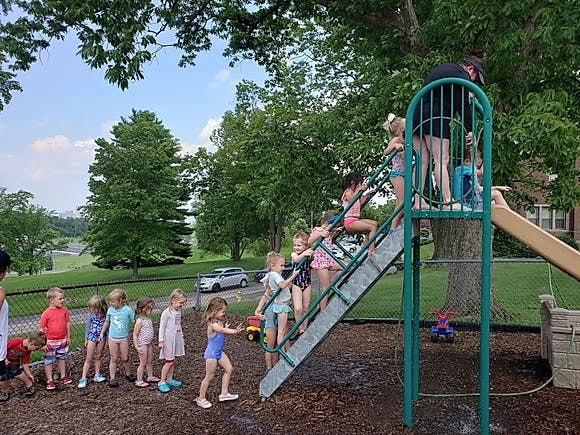 Children playing on a playground slide
