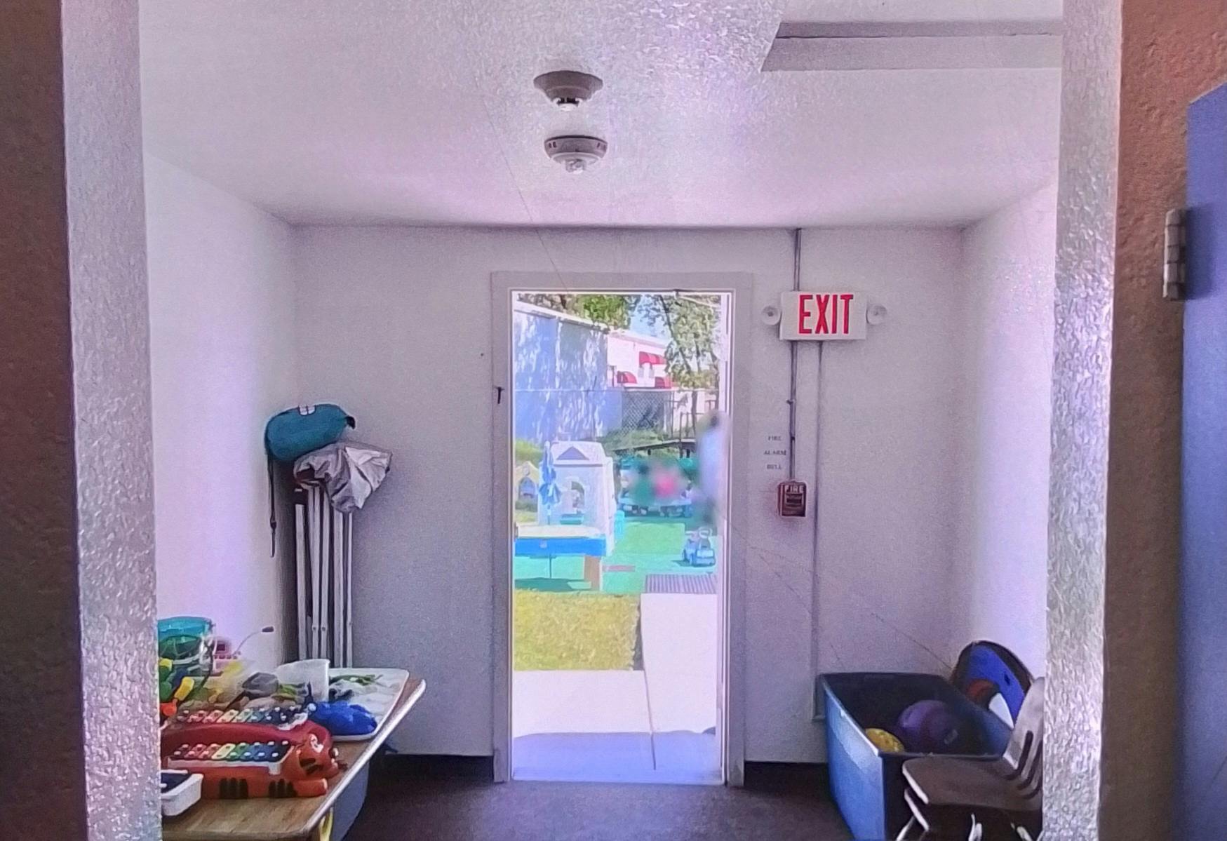 Doorway with an exit sign above it, leading to an outdoor area