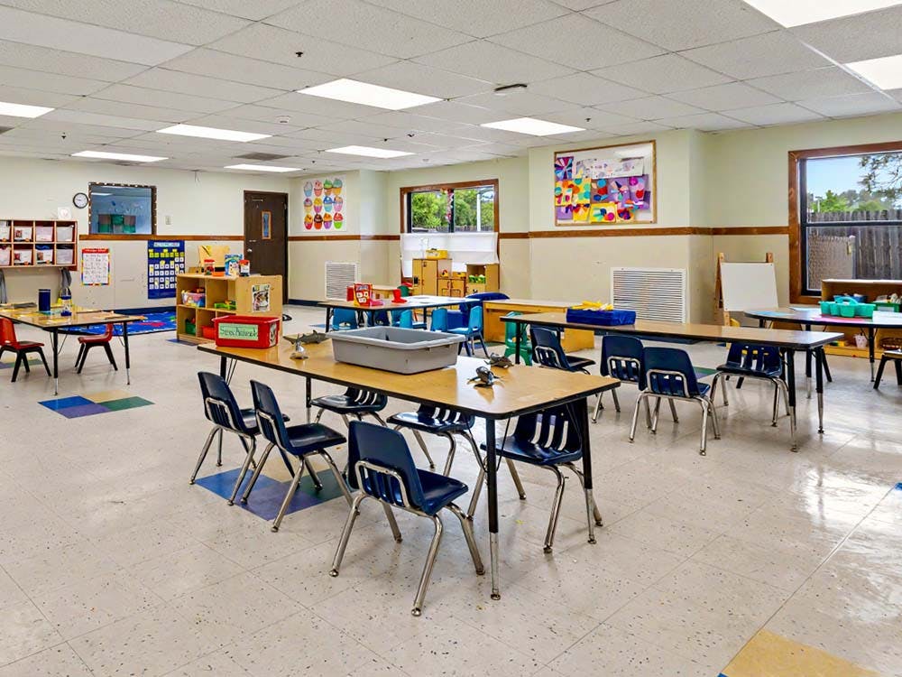 Empty classroom with small tables and chairs