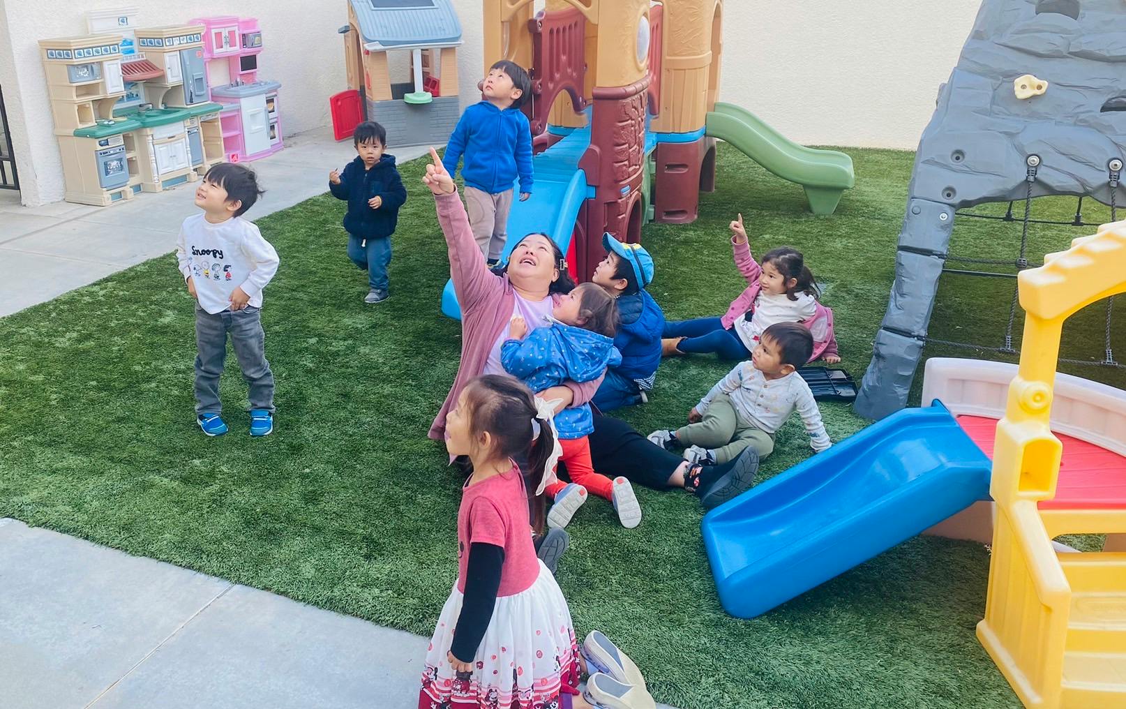 Adults and children playing on a playground